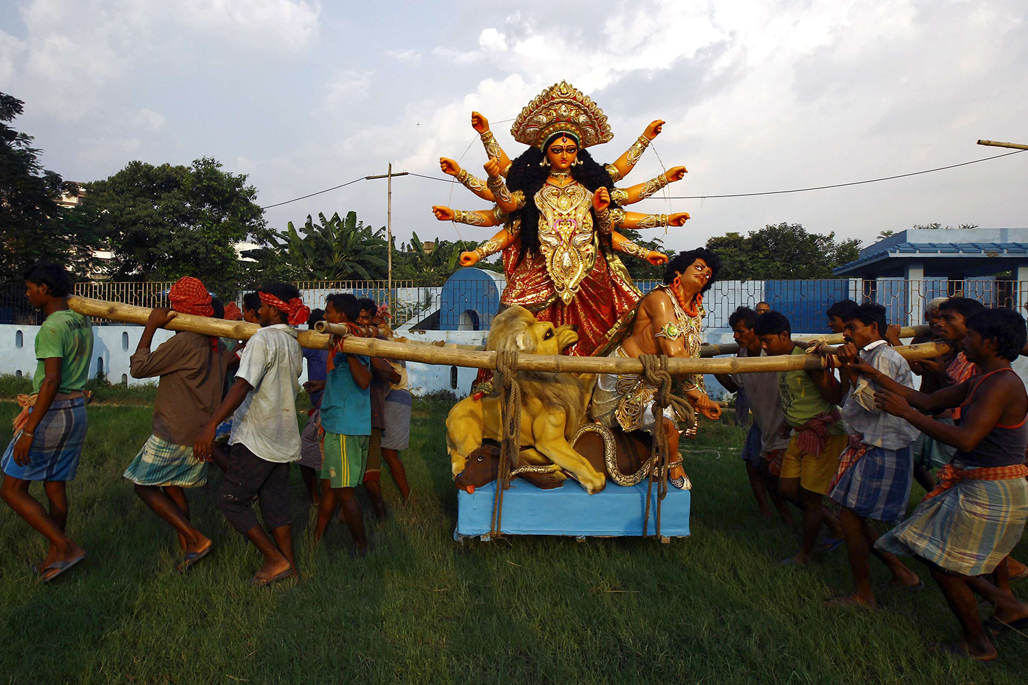 Labourers carry an idol of the Hindu goddess Durga towards a pandal, or a temporary platform, ahead of the Durga Puja festival in Kolkata